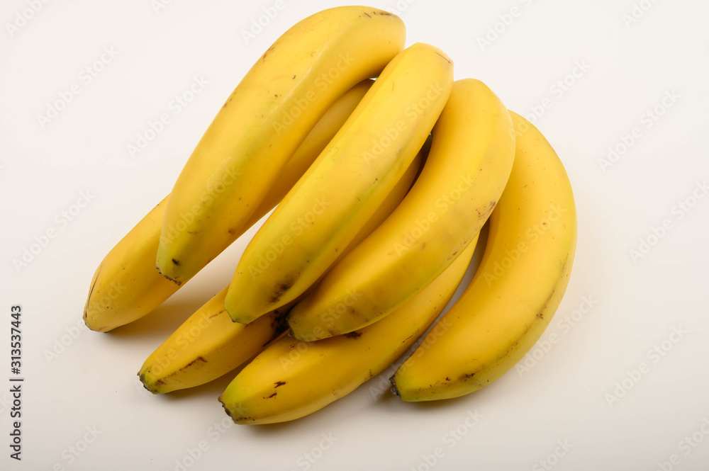 Bunch of ripe yellow bananas on a white background. Close up.