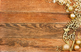 Christmas greeting card. Golden balls, deer and golden snowflake on a wooden background. Top view. Text space.