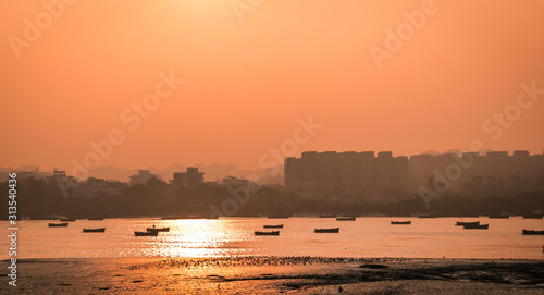 Panoramic silhouette of surat city while sun rising near ONGC bridge photo