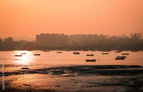 Fotografie Panoramic silhouette of surat city while sun rising near ONGC bridge