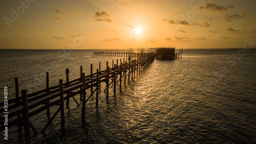 Sunset over a long dock  pier  in the ocean in Zanzibar  Tanzania
