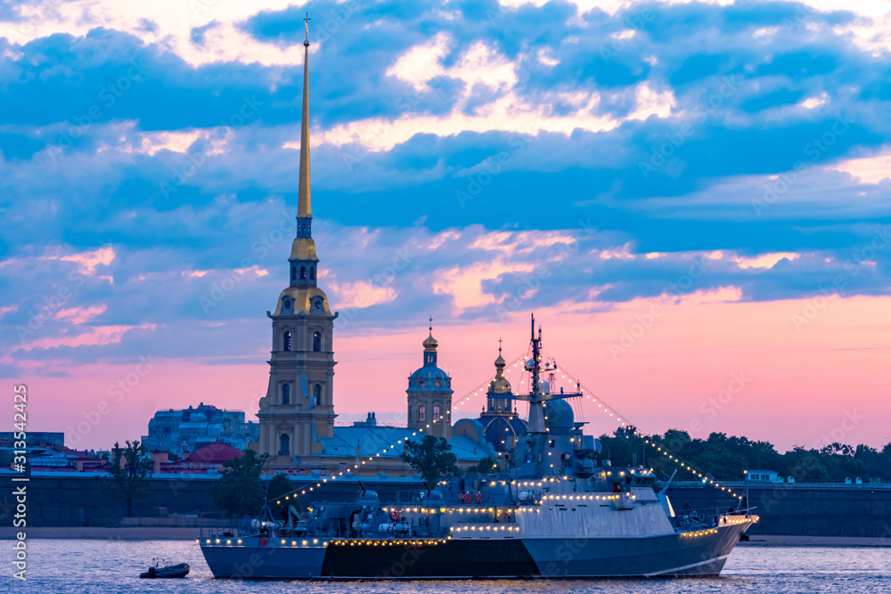 Saint Petersburg. Russia. Warship with garlands in the waters of the Neva. Ship on the background of the Peter and Paul fortress. White nights in Petersburg. Festive St. Petersburg. Cities of Russia