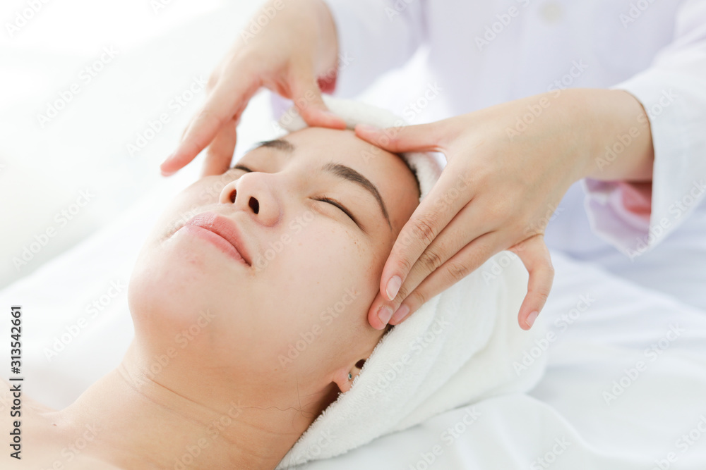 Asian young woman getting spa treatment at beauty salon. spa face massage. facial beauty treatment