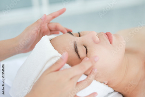 Asian young woman getting spa treatment at beauty salon. spa face massage. facial beauty treatment © chayathon2000