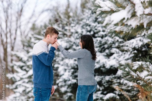 Love Valentine Concept. people, season, love and leisure concept - happy couple hugging and kissing outdoors in winter. Romantic couple in love feeling happiness romance Valentine . love copy space.