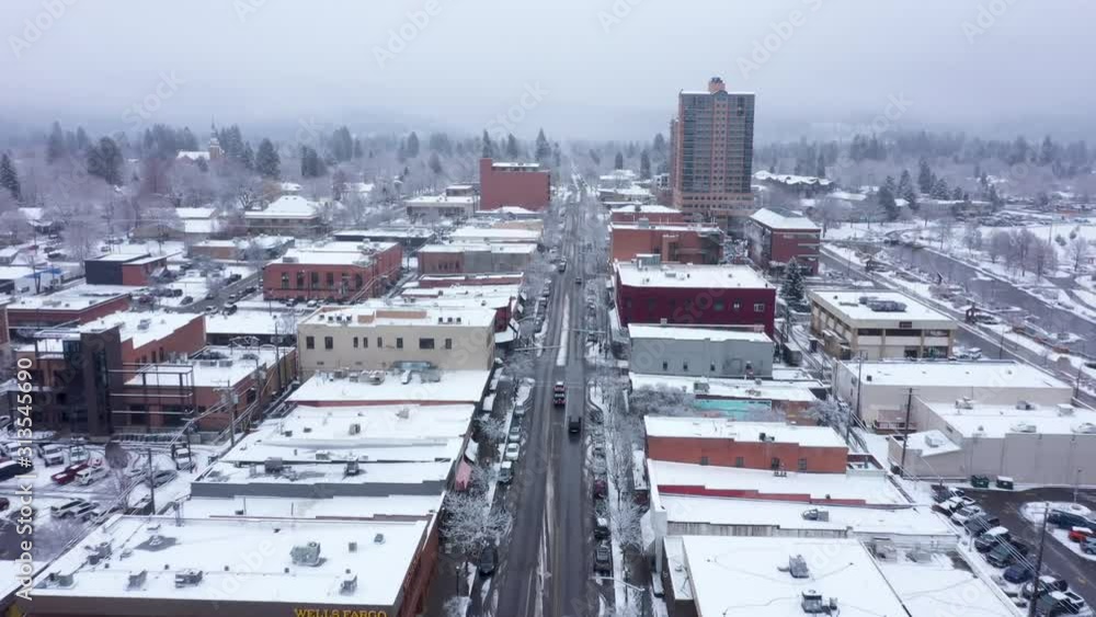 Aerial shot going up Sherman Avenue in downtown Coeur d'Alene Idaho on winter day with fresh snow. Aerial shot going up Sherman Avenue in downtown Coeur d'Alene Idaho on winter day with fresh snow.
