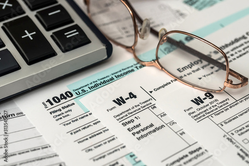 Paper blanks of 1040, w4 and w9 tax form close up