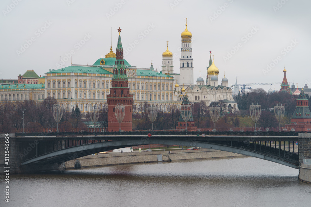 Moscow downtown cityscape. Kremlin Towers, the Residence of the President of Russian Federation, Ivan the Great Bell Tower, Dormition Cathedral, Bolshoy Kamenny Bridge in overcast winter day