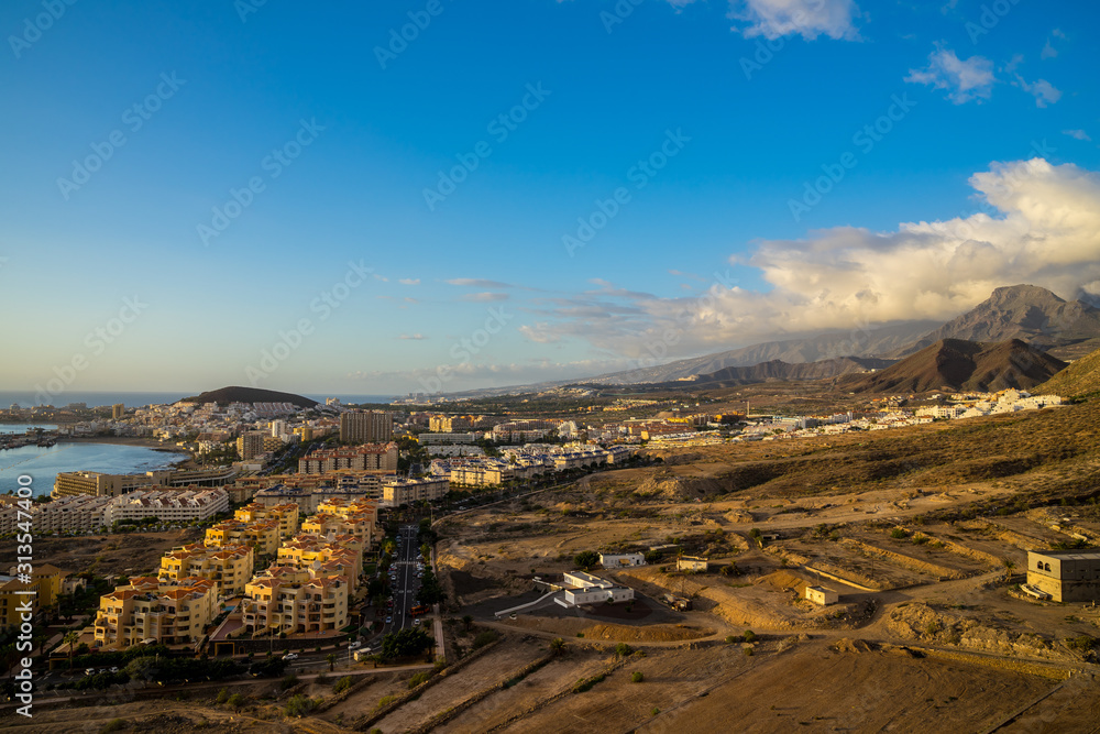 Spain, Tenerife, Aerial view above los christianos houses, a tourist resort city south of the island at the coast at sunset