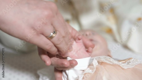 Wallpaper Mural Mom strokes small hands of a child who is in a crib Torontodigital.ca