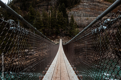 Low Angle View of Suspension Bridge Over Rapid River