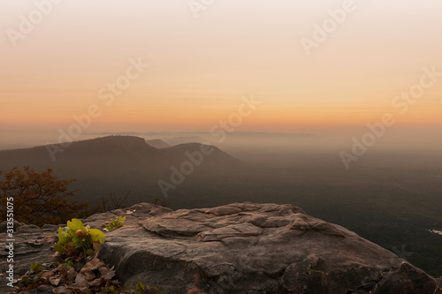 Cliff stone located part of the mountain rock on the top hill with mountain view at sun rise time.Mock up the pedestal photo