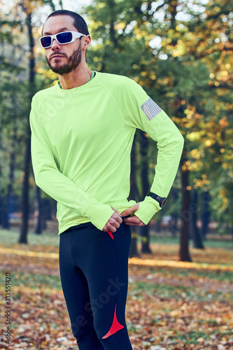 Man preparing for jogging / exercising in the park.