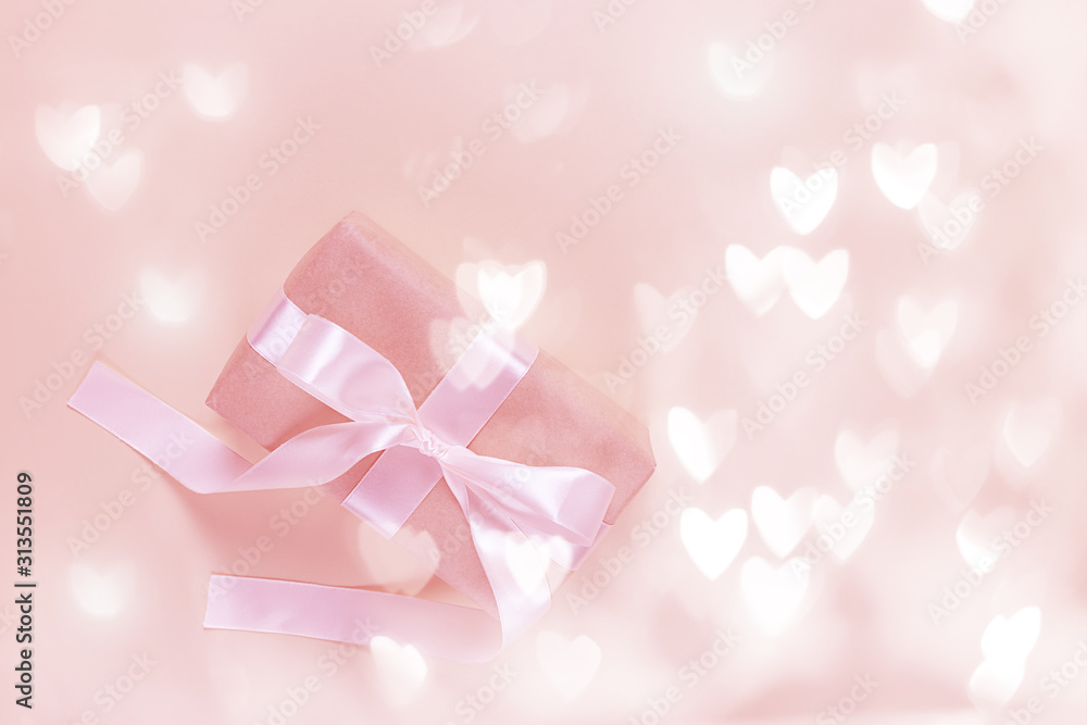 Gift box with hearts on a pink background with bokeh. Valentine's day. Gift box with hearts on a pink background with bokeh. Valentine's day.