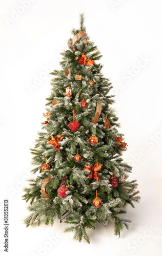 Magnificently decorated christmas tree in front of a white backround