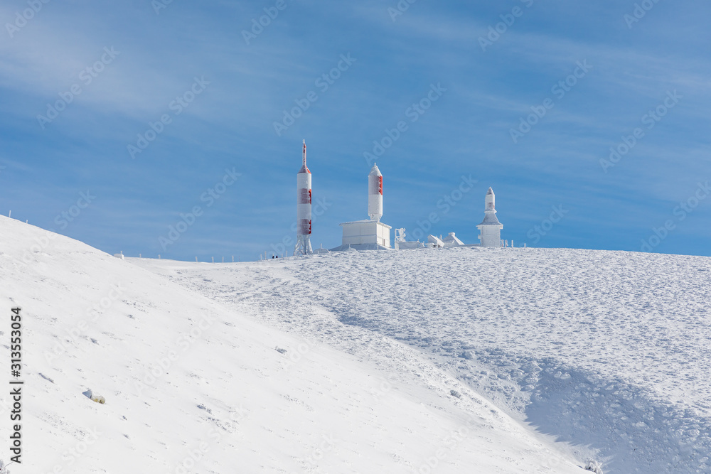TV and radio antennas known as La Bola del Mundo in Navacerrada, Madrid, Spain, on a snow-covered mountain.