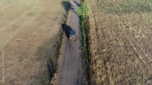 Aerial drone following an off-road truck moving over unpaved dusty way very dry landscape showing dust from soil picked up by wind wasteland located in Africa 4k high resolution footage quality