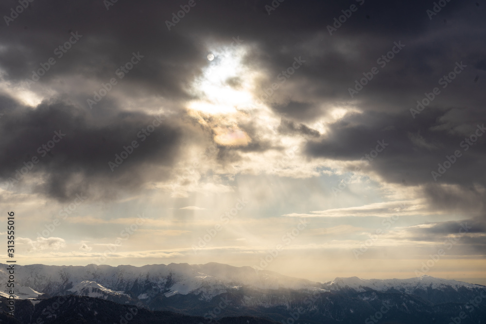 Sun rays of light on snow-capped mountain peaks Sun rays of light on snow-capped mountain peaks
