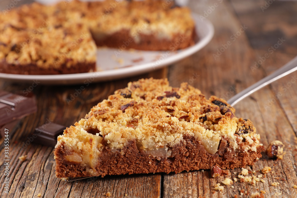 crumble with pear and chocolate on wood background