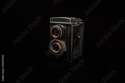 Retro camera on black background, isolated object