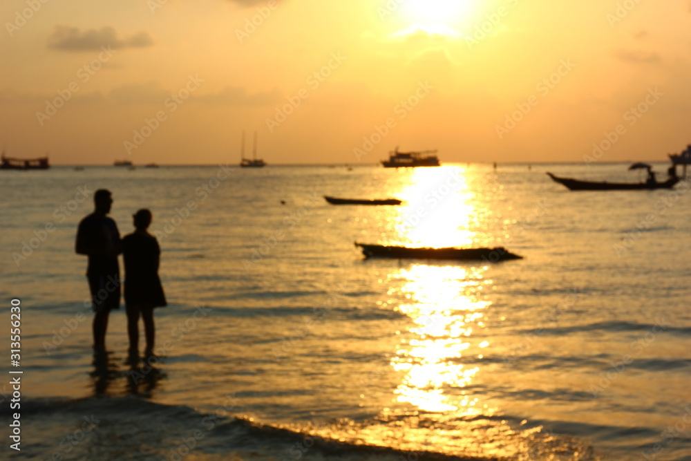 blur picture of silhouette couple on beach in sunset time,lover is celebrate in Valentine day by say love and propose.man and woman are getting marry are pre wedding on beach in best time.
