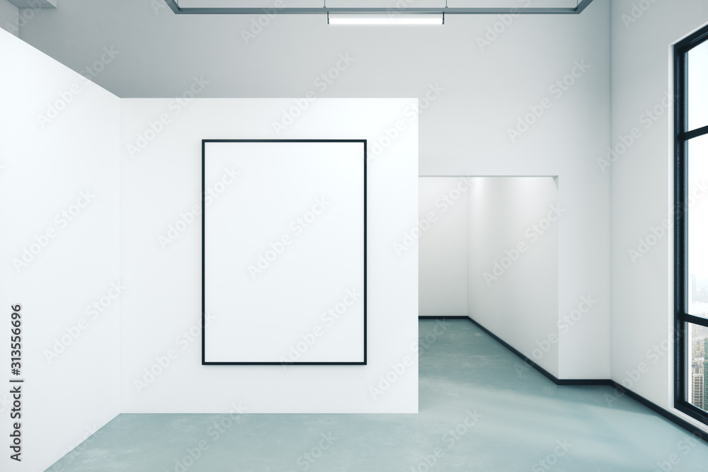 White wall with blank poster