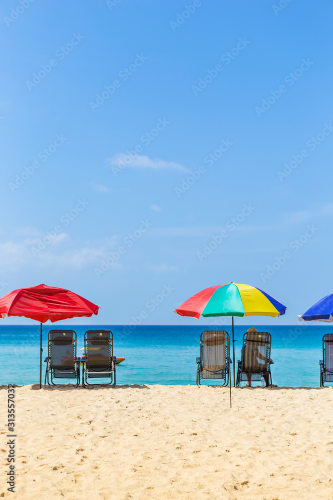 Vacation time, Relaxing at the beach, summer outdoor day light, Thailand holiday destination, colorful beach umbrella with beach chairs on the beach