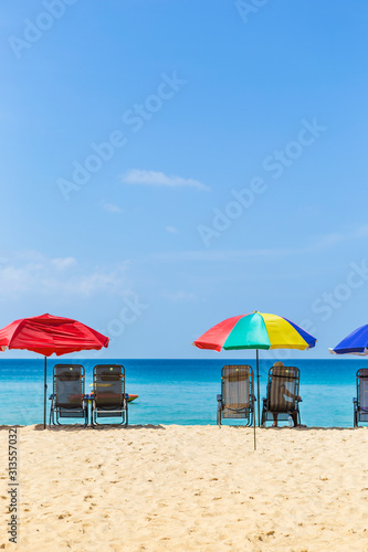 Vacation time, Relaxing at the beach, summer outdoor day light, Thailand holiday destination, colorful beach umbrella with beach chairs on the beach