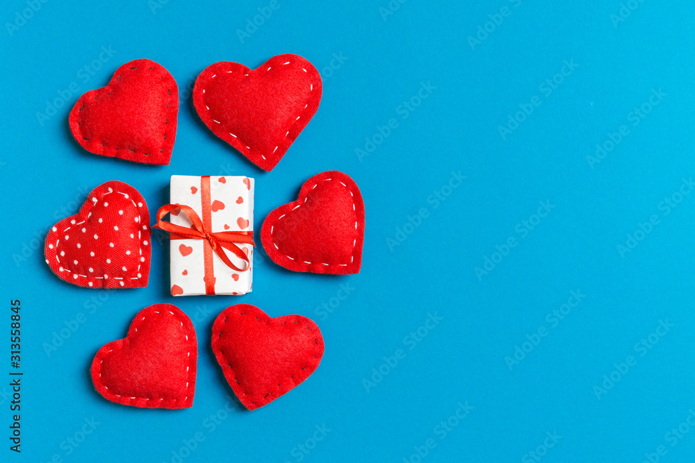 Obraz premium Top view colorful valentine background made of gift boxes and red textile hearts. Valentine's Day concept with copy space