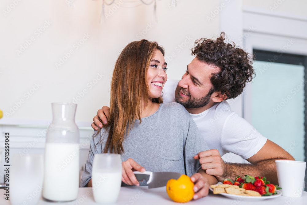 happy young couple have fun in modern kitchen indoor while preparing fresh fruits and vegetables food salad. Beautiful young couple talking and smiling while cooking healthy food in kitchen at home. happy young couple have fun in modern kitchen indoor while preparing fresh fruits and vegetables food salad. Beautiful young couple talking and smiling while cooking healthy food in kitchen at home.