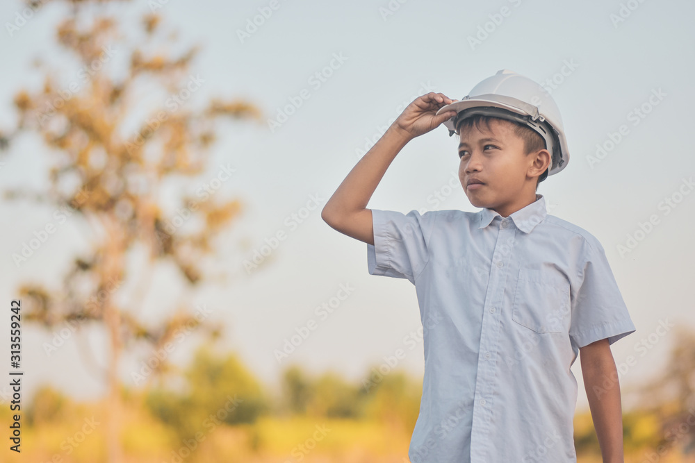 Boy with white helmet hard hat safety standing out doors copy spec Boy with white helmet hard hat safety standing out doors copy spec