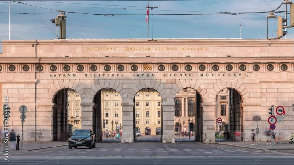 Exterior of outer castle gate (Burgtor) from Ringstrasse timelapse in Vienna city in sunny day. Blue cloudy sky. The gate of Hofburg area was erected in 1818