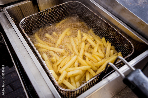 The chef cooking french fries. Restaurant.