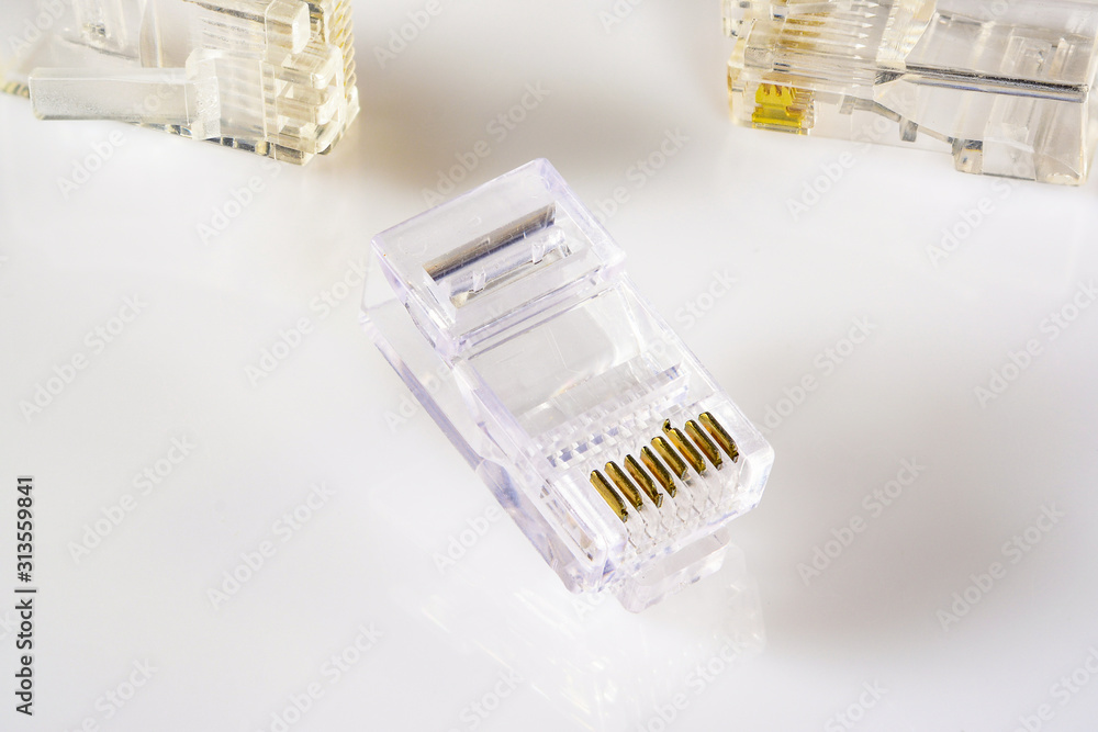 Connector rj-45. Transparent connector rj45 for network and internet. Close-up macro on gloss white background with shadow. Connector rj-45. Transparent connector rj45 for network and internet. Close-up macro on gloss white background with shadow.