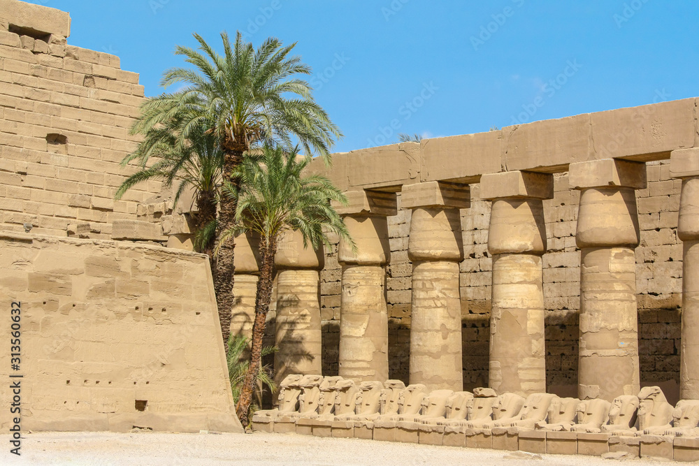 Karnak Temple Complex in Luxor, Egypt. Ancient temple colonnade with row of cryosphinxes. Karnak Temple Complex in Luxor, Egypt. Ancient temple colonnade with row of cryosphinxes.