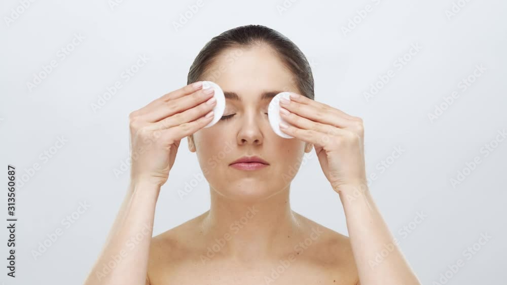 Studio portrait of young, beautiful and natural blond woman applying skin care cream. Face lifting, cosmetics and make-up. Studio portrait of young, beautiful and natural blond woman applying skin care cream. Face lifting, cosmetics and make-up.