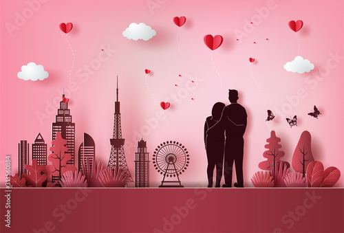 Young couple in love watching beautiful view of city with many heart floating.