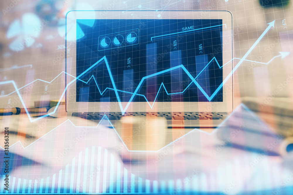 Financial graph colorful drawing and table with computer on background. Double exposure. Concept of international markets. Financial graph colorful drawing and table with computer on background. Double exposure. Concept of international markets.