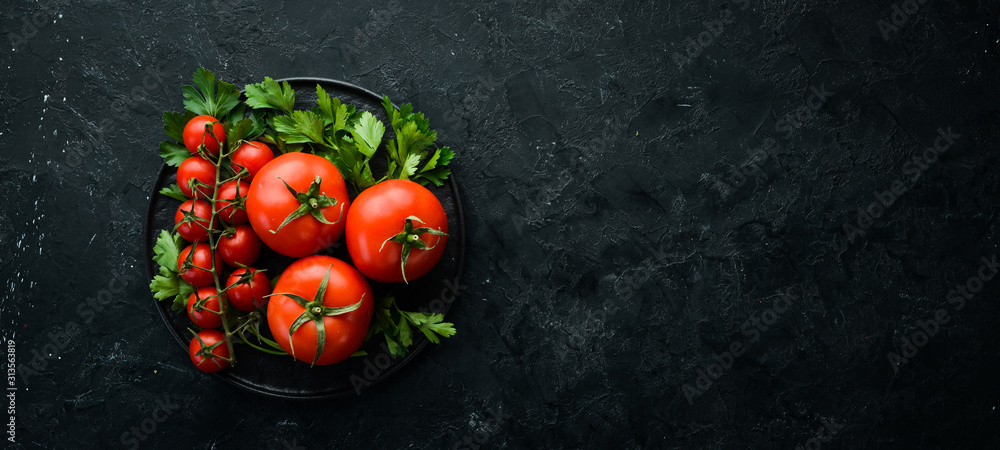Fresh red tomatoes on a dark background. Vegetables. Top view. Free space for your text. - obrazy, fototapety, plakaty 