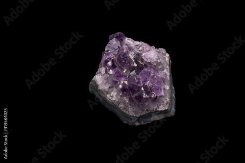 Purple rough Amethyst quartz crystals geode isolated on black