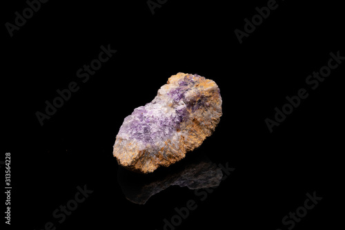 Purple rough Amethyst quartz crystals geode isolated on black