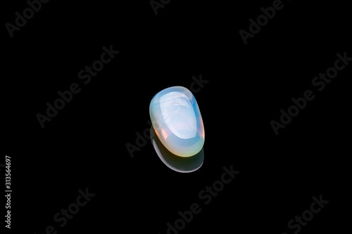 Opalite gemstone isolated on black background. Macro shot.