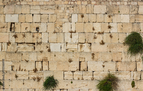 Western wall world heritage religion site for pray and hope ancient building stone background texture in Israel, copy space photo