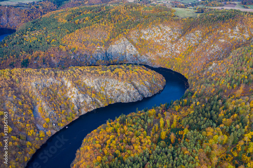 Beautiful Vyhlidka Maj, Lookout Maj, near Teletin, Czech Republic. Meander of the river Vltava surrounded by colorful autumn forest viewed from above. Tourist attraction in Czech landscape. Czechia. photo