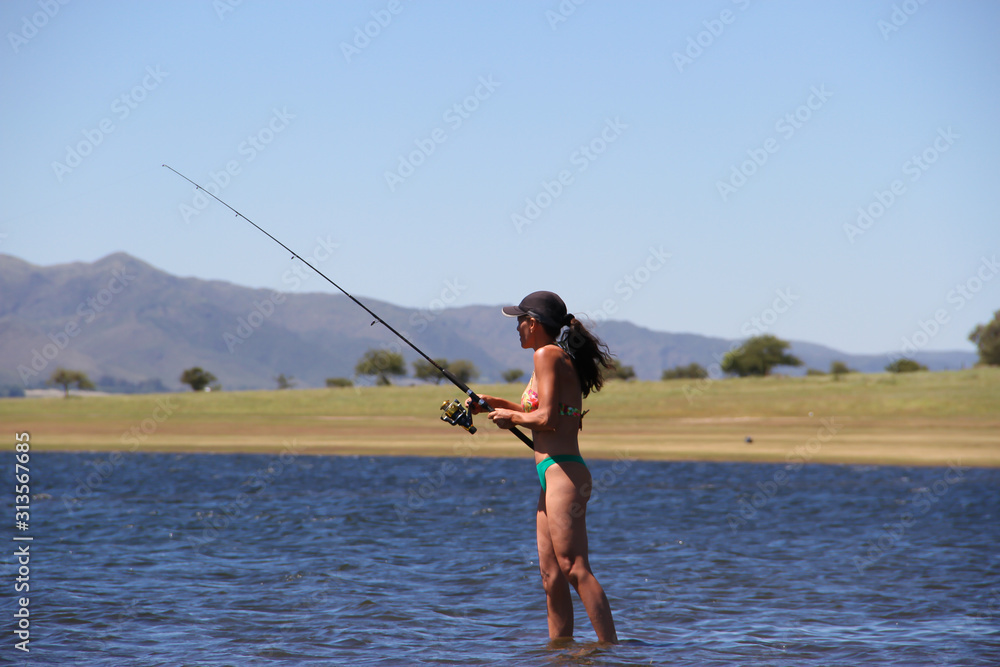 beautiful young woman fishing the mountain lake beautiful young woman fishing the mountain lake