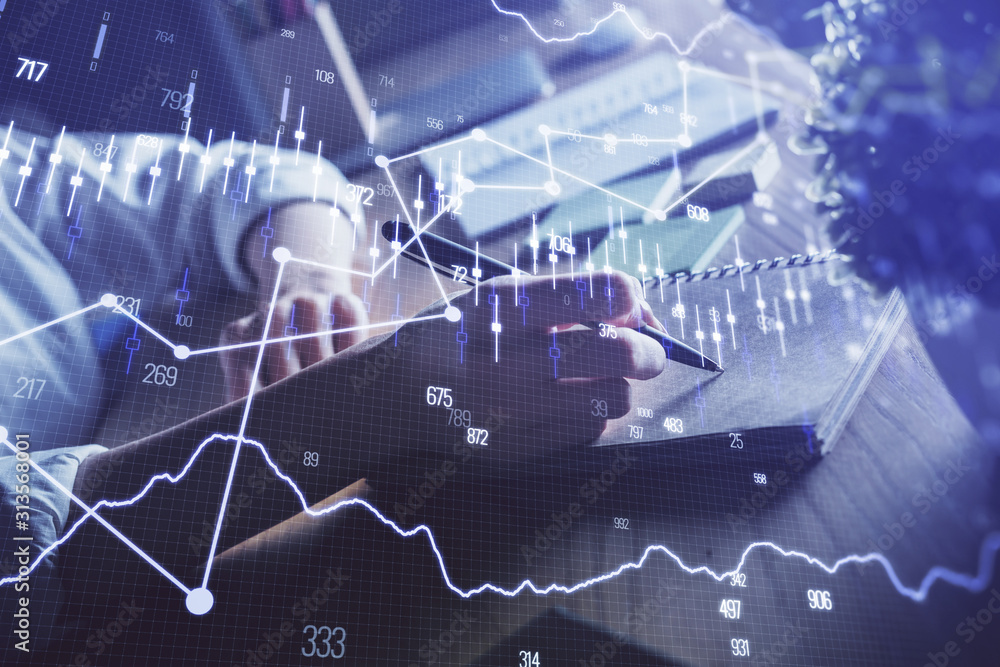 Financial forex charts displayed on woman's hand taking notes background. Concept of research. Double exposure Financial forex charts displayed on woman's hand taking notes background. Concept of research. Double exposure