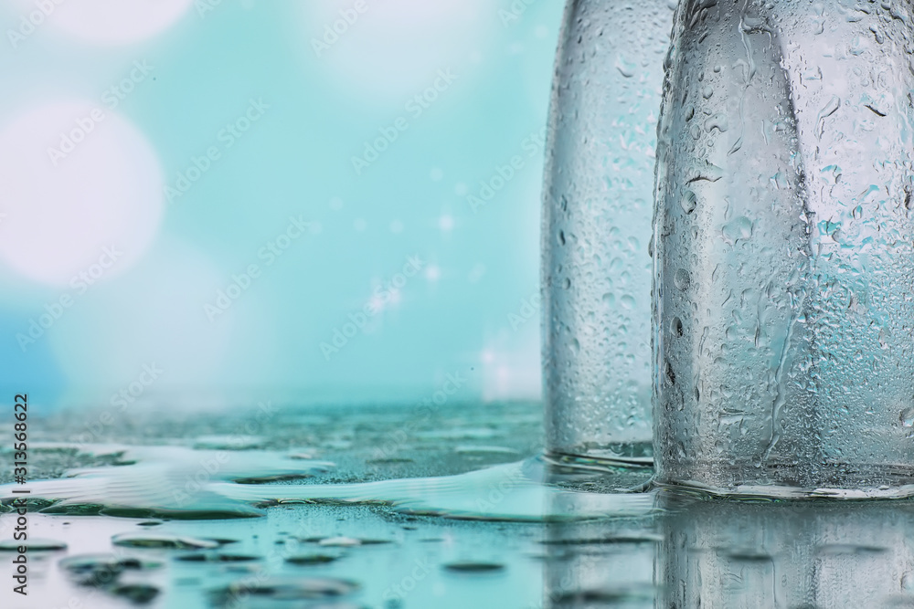 Background with tall glasses for sparkling wines. Champagne and spray in glass glasses. Celebratory drink with reflection.