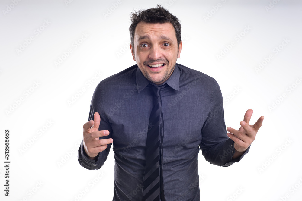Portrait of a young dude isolated on white, wearing a grey shirt and a black tie acting excited, surprised, pulling faces . Portrait of a young dude isolated on white, wearing a grey shirt and a black tie acting excited, surprised, pulling faces .