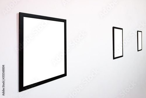 Empty blank picture wooden frame in interior on white wall