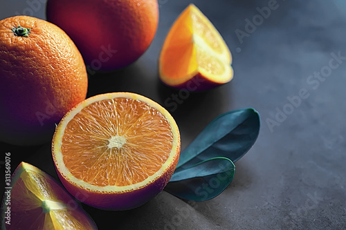Stampa su Tela Orange citrus fruit on a stone table. Orange background.